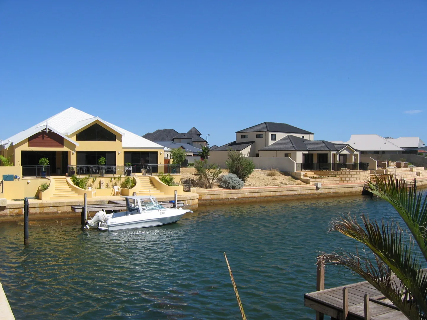Canal-side homes and boats in Wannanup, in the Mandurah region